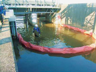 An oil fence is installed across the Kisogawa Canal to address a water quality hazard